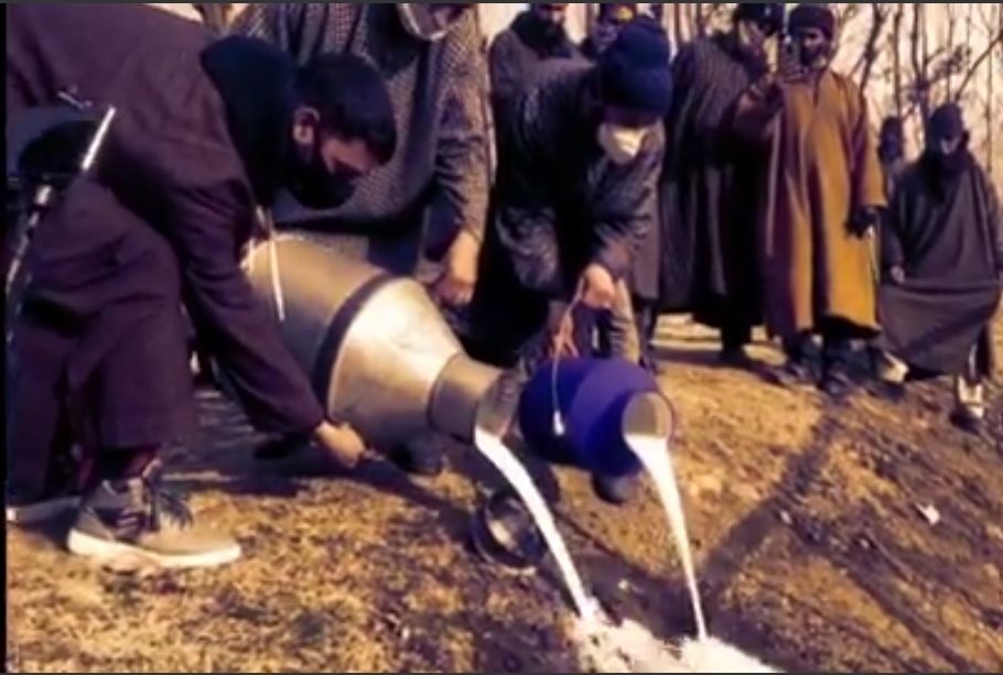 Dairy farmers empty milk canes on the ground after finding no consumers in Central Kashmirs Ganderbal
